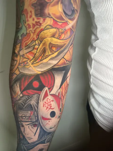 Anime forearm section of a Naruto sleeve with a red fox mask, a shinobi portrait and a Sharingan eye in flame