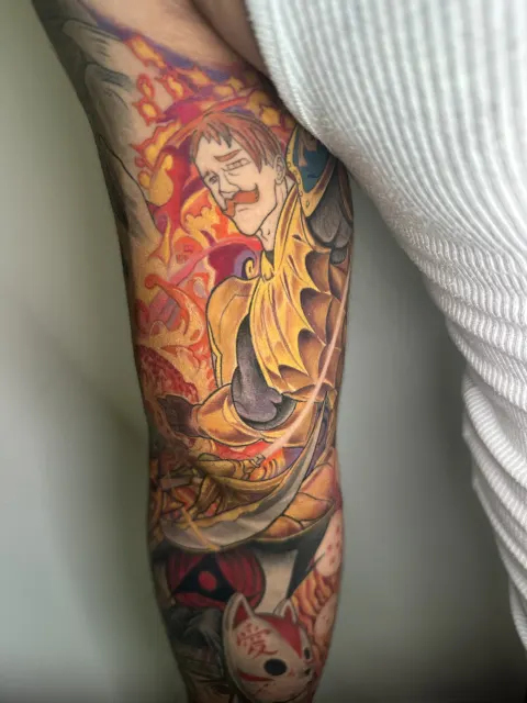 Upper section of the anime sleeve where a golden winged beast rises out of orange flame