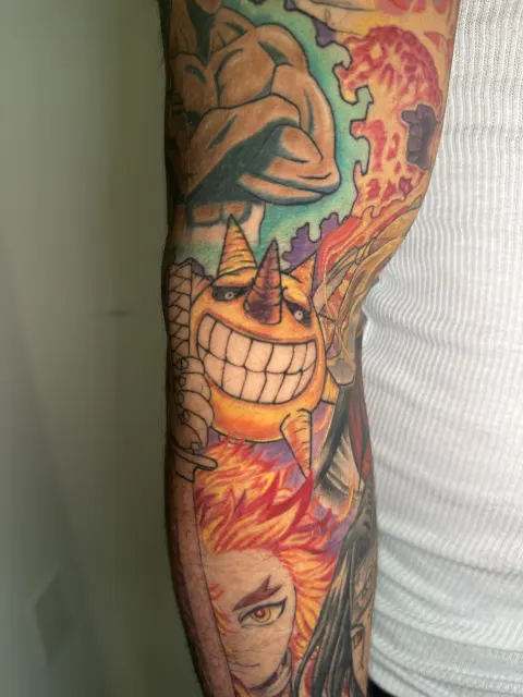 Full view of the anime sleeve joining the horned grinning figure and the flame-haired swordsman