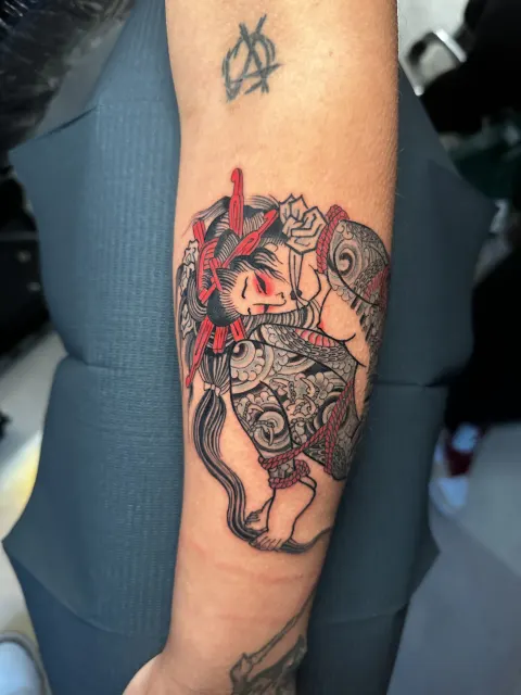 Neo-Oriental forearm tattoo of a wild boar entwined with a serpent