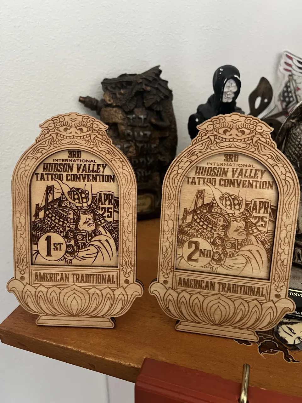 Two carved wooden awards from the 3rd International Hudson Valley Tattoo Convention, first and second place, American Traditional
