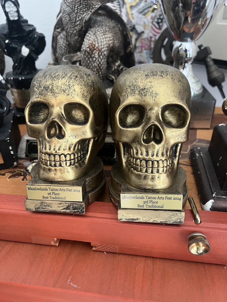 Two skull trophies engraved Meadowlands Tattoo Arts Fest 2024, first place and third place, Best Traditional